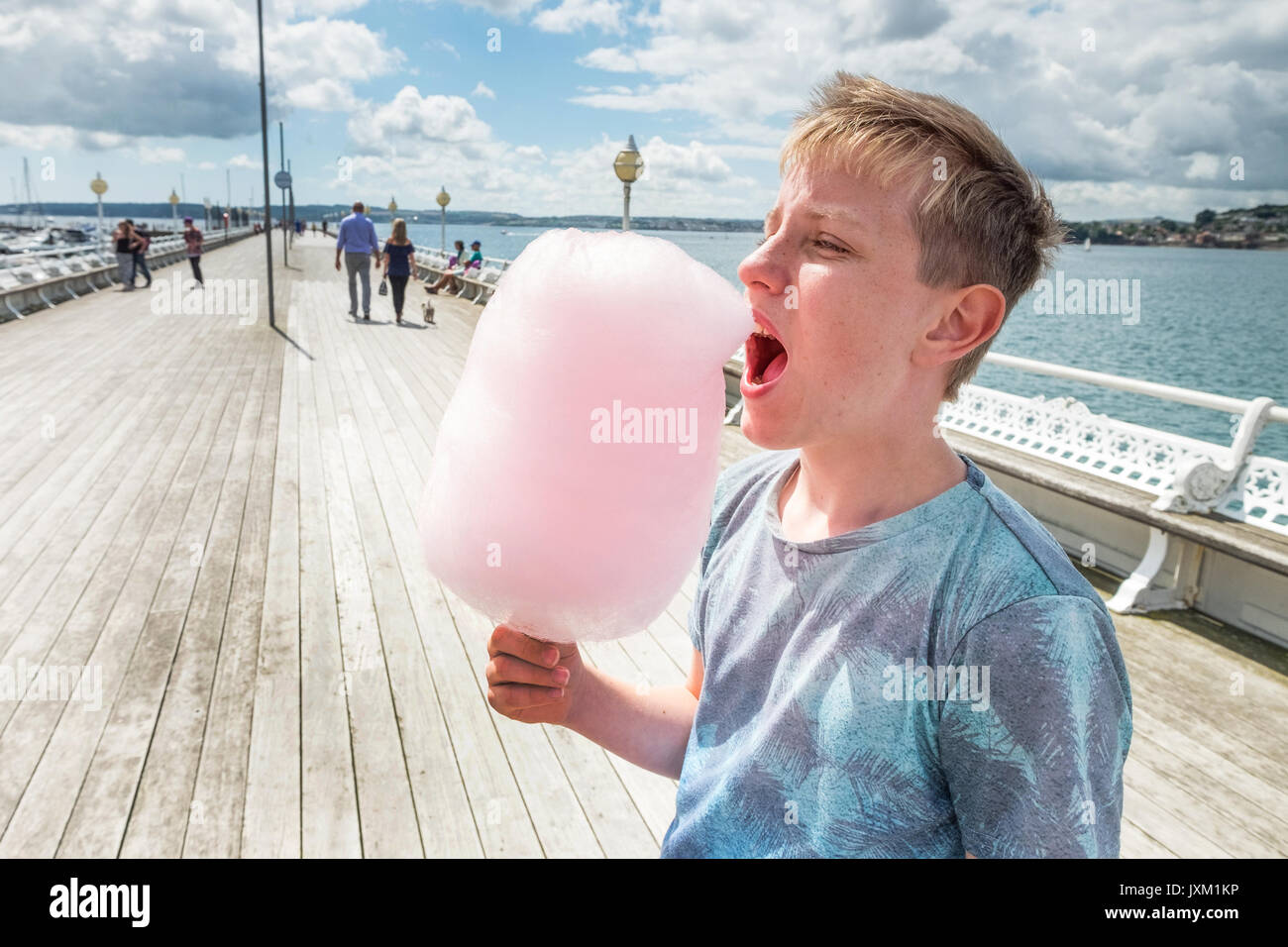 A tourist eating candy floss on Princess Pier in Torquay, Torbay, Devon, UK Stock Photo