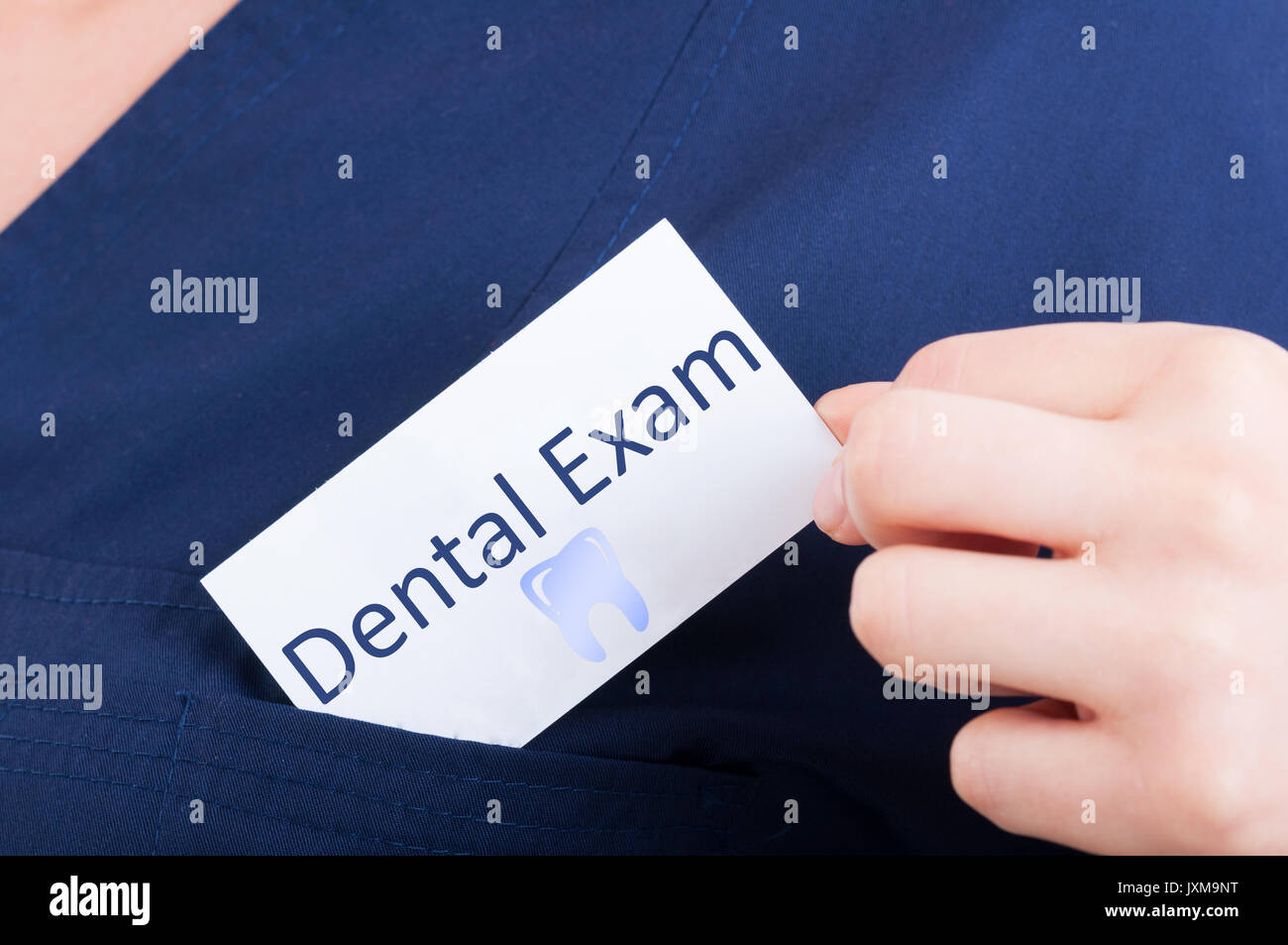 Closeup hand hold visit card with dental exam as periodic appointment
