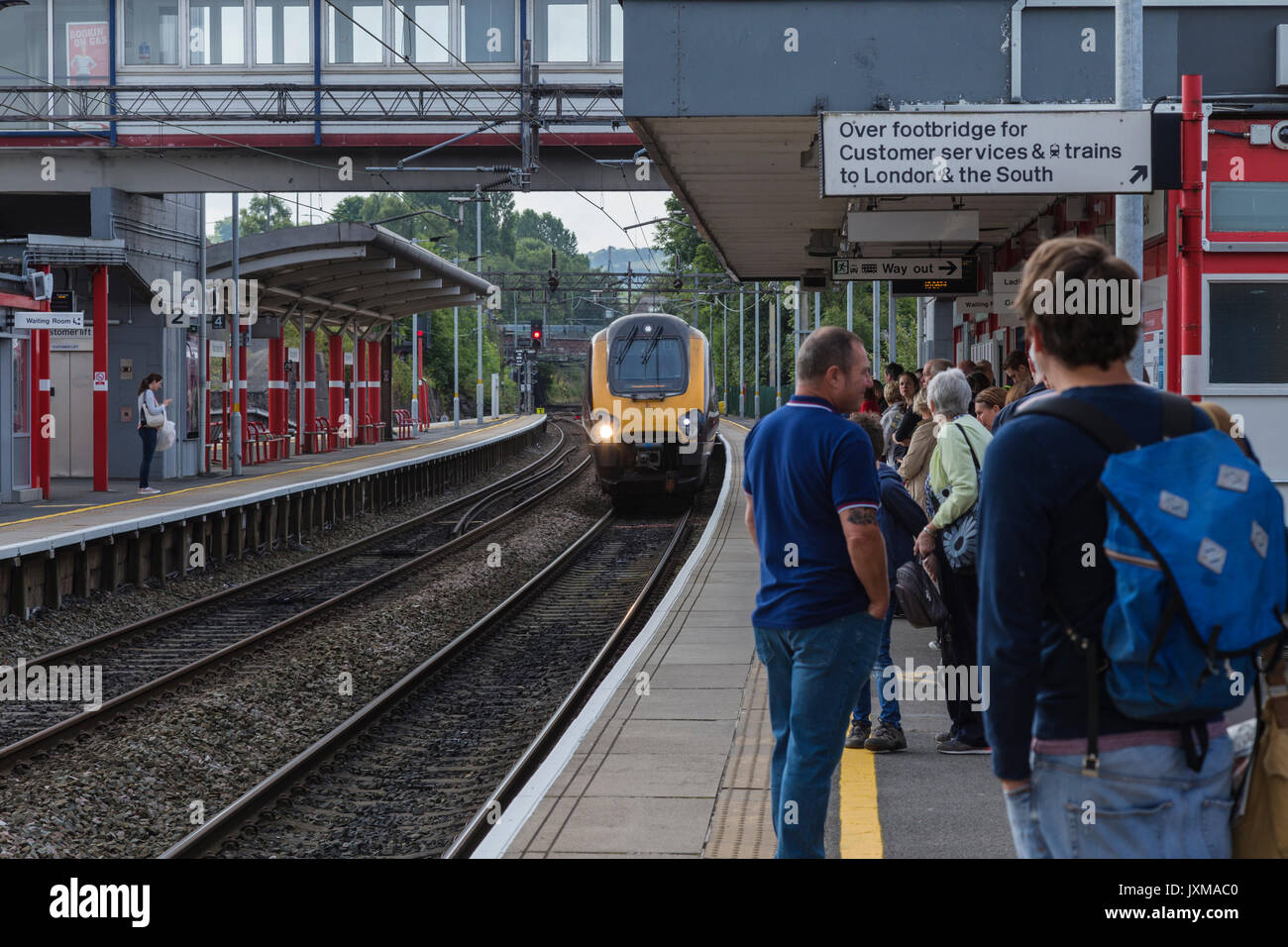 Passengers Waiting as Train Pulls in to Platform at Macclesfield Railway Station Stock Photo