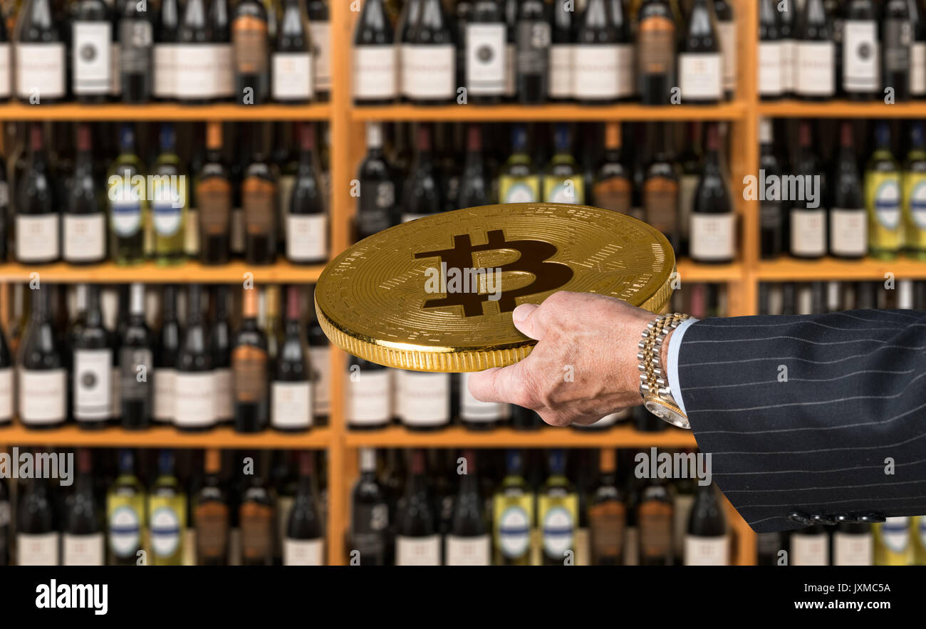 Offering bitcoin for bottles of wine in store Stock Photo - Alamy