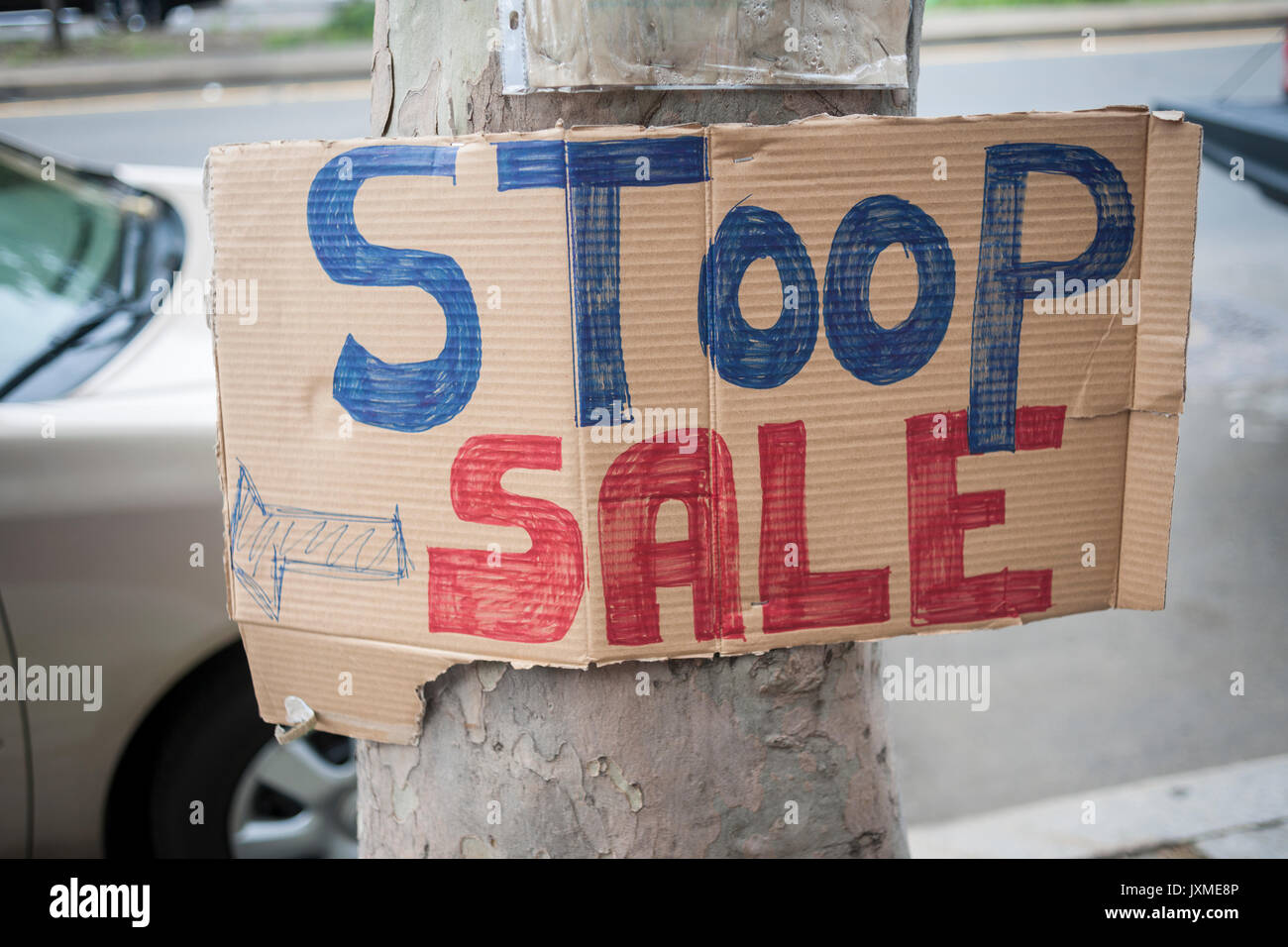 A handmade 'Stoop Sale' sign in Harlem in New York is seen on Sunday, August 6, 2017. (© Richard B. Levine) Stock Photo