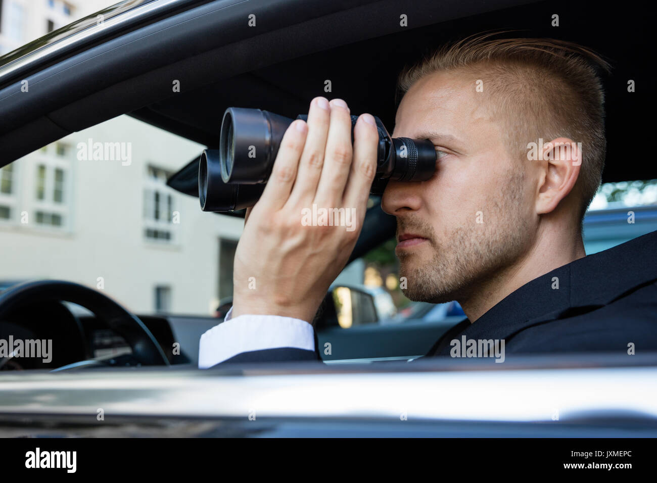 Man binoculars spying hi-res stock photography and images - Alamy