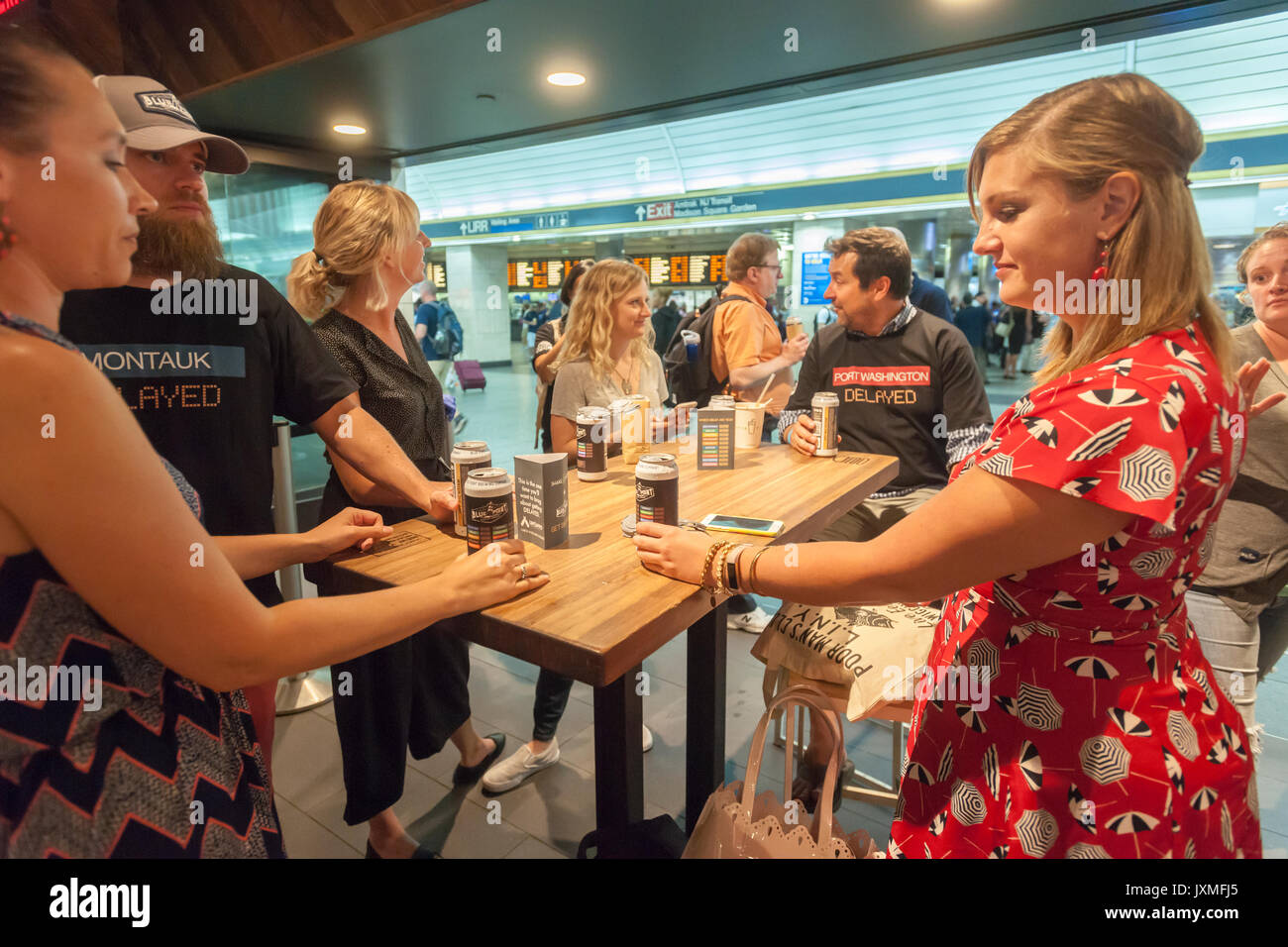Throngs of hungry burger lovers and thirsty beer drinkers flock to the Shake Shack in Penn Station in New York on Monday, August 14, 2017 for the happy hour debut party of Blue Point Brewery's 'Delayed' beer. Reacting to the 'Summer of Hell' that Long Island Railroad passengers are going through because of maintenance track work Blue Point Brewery created their 'Delayed' pilsner beer with the graphics on the can a riff on the LIRR departure boards. The first 100 customers got a free burger with the purchase of a can of 'Delayed'.  ( © Richard B. Levine) Stock Photo