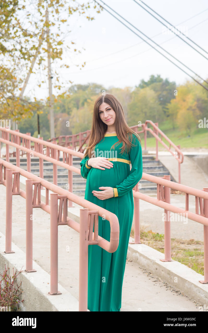 The pregnant girl on walk in city park Stock Photo - Alamy