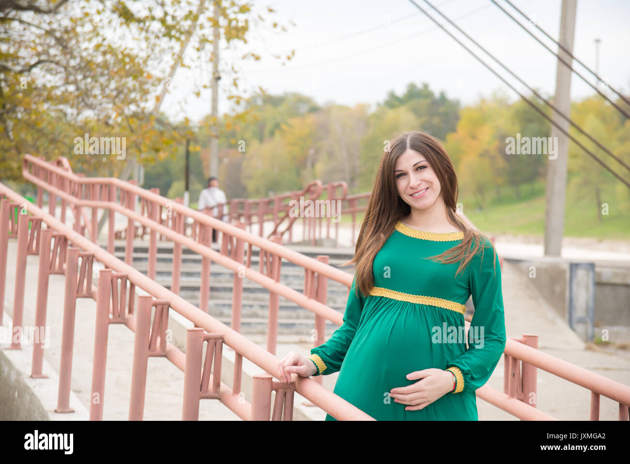 The pregnant girl on walk in city park Stock Photo - Alamy