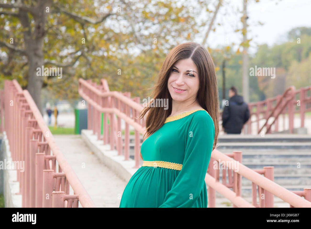 The pregnant girl on walk in city park Stock Photo - Alamy