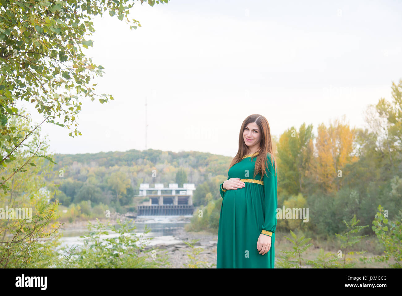 The pregnant girl on walk in city park Stock Photo - Alamy