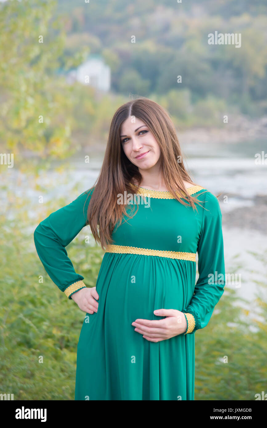 The pregnant girl on walk in city park Stock Photo - Alamy