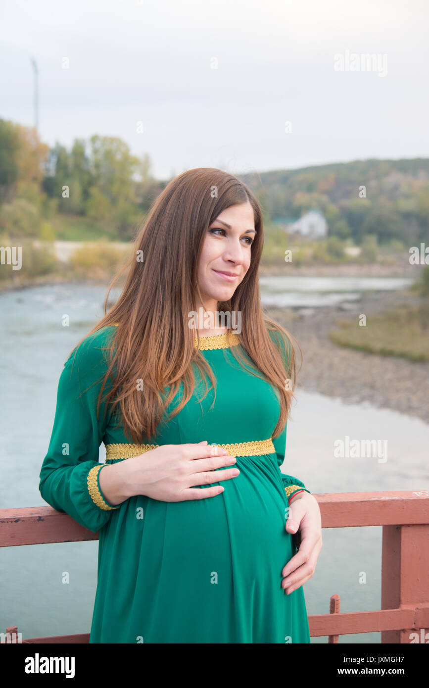 The pregnant girl on walk in city park Stock Photo - Alamy