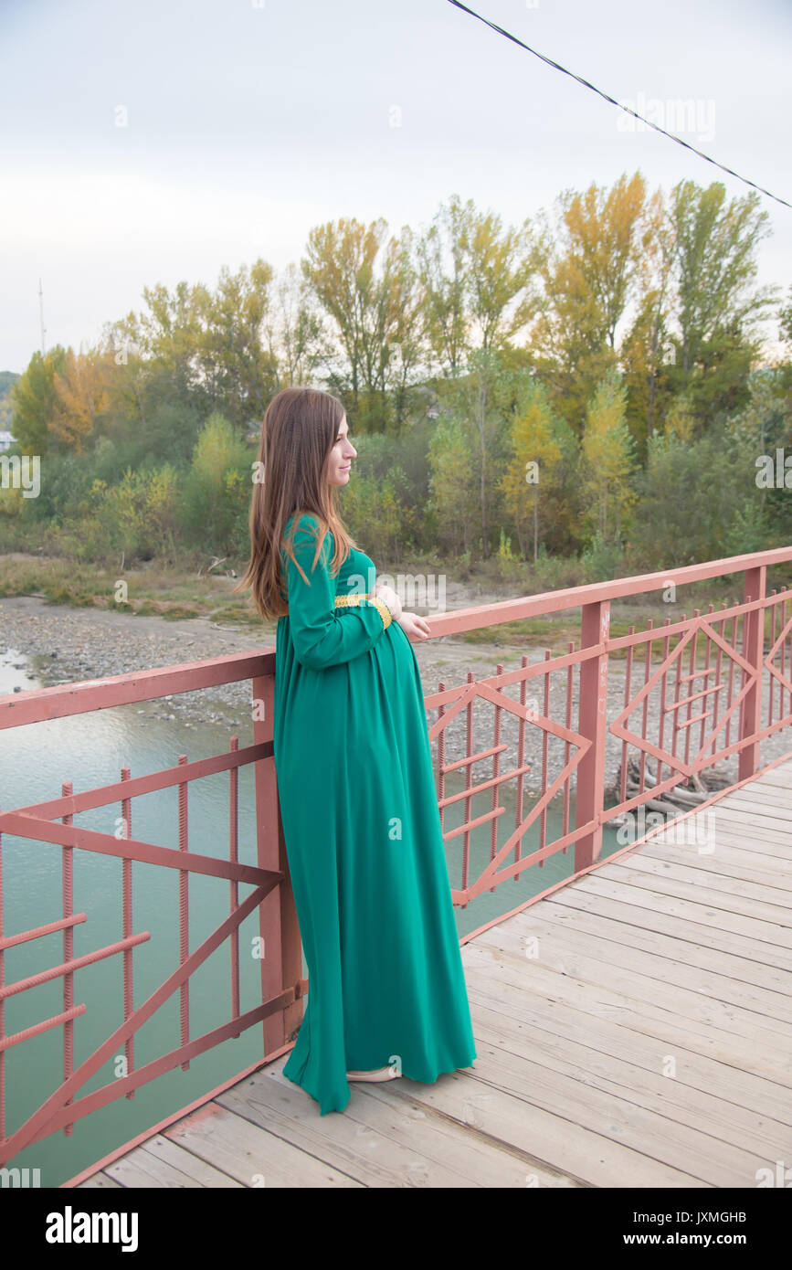 The pregnant girl on walk in city park Stock Photo - Alamy