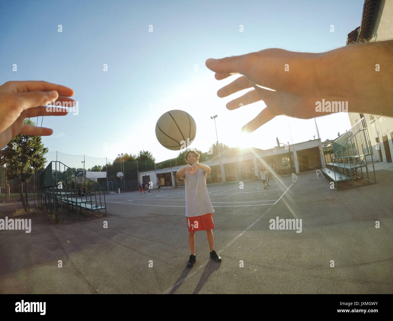 Point of view image of man throwing basketball at teammate Stock Photo