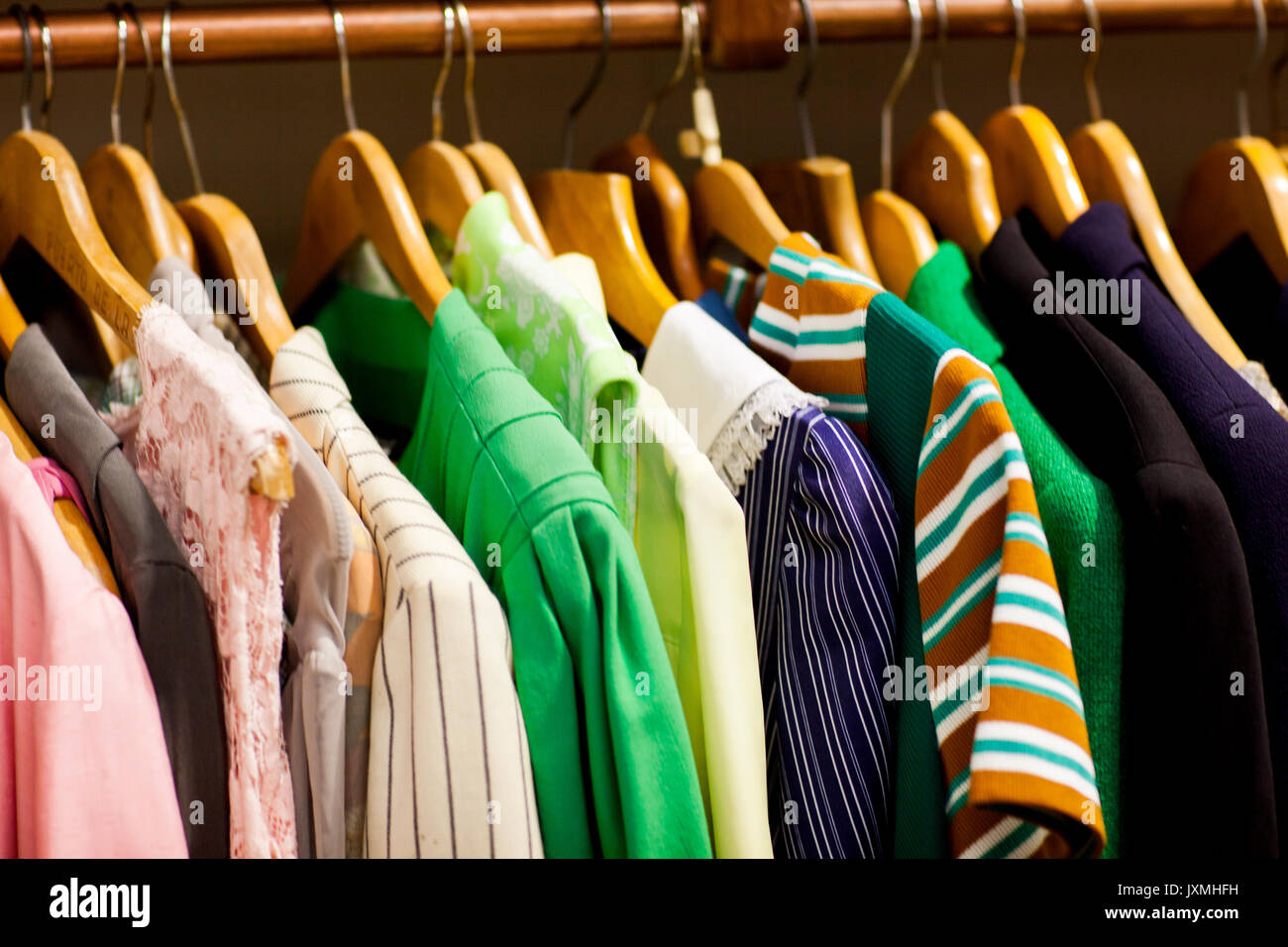 Vintage clothes on clothes rail in antique and vintage emporium Stock