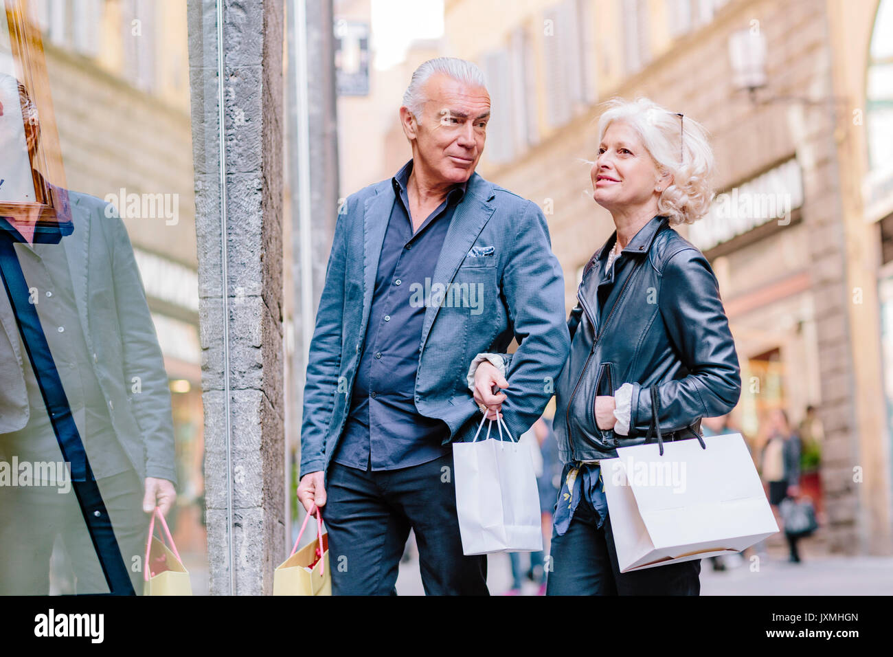 Tourist couple window shopping on city street, Siena, Tuscany, Italy Stock Photo