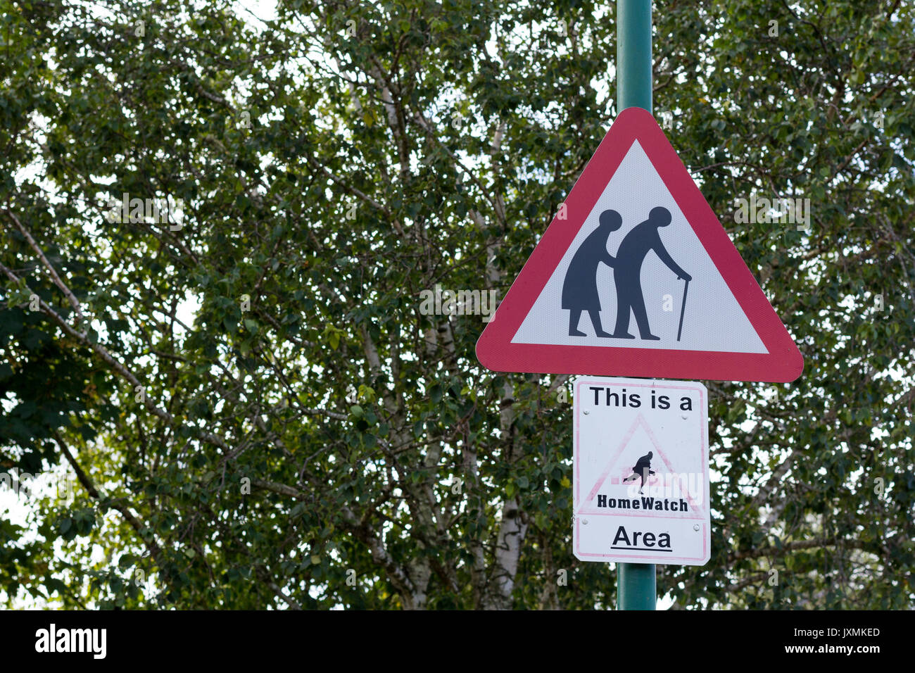 Old people warning red triangular road sign, This is a HomeWatch Area sign, Dorset, UK Stock Photo