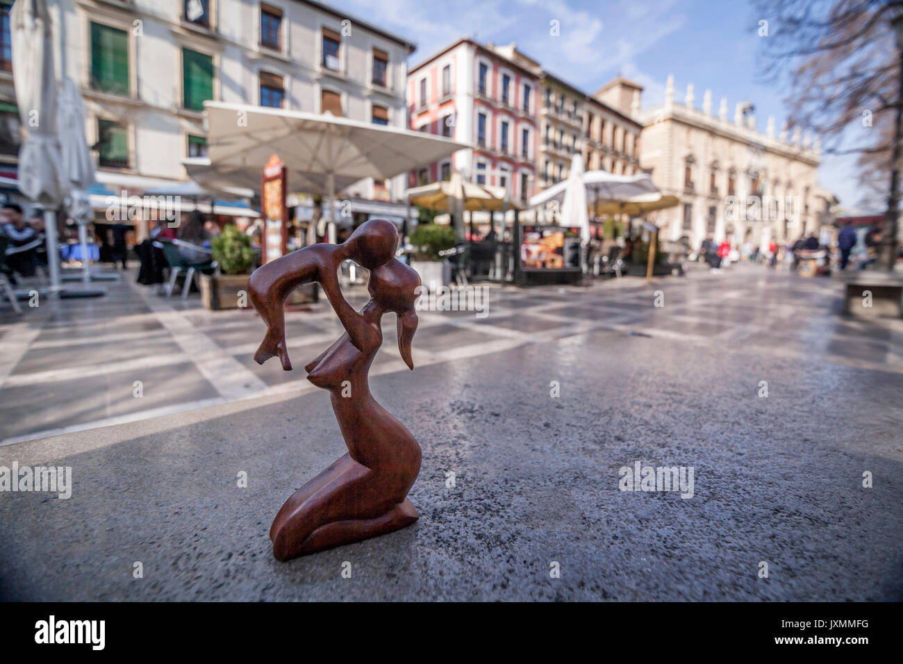 Figure hand made wooden on a stone bench in near real Chancilleria of Granada, the Superior Court of Justice of Andalucia, Granada, Andalusia, Spain Stock Photo