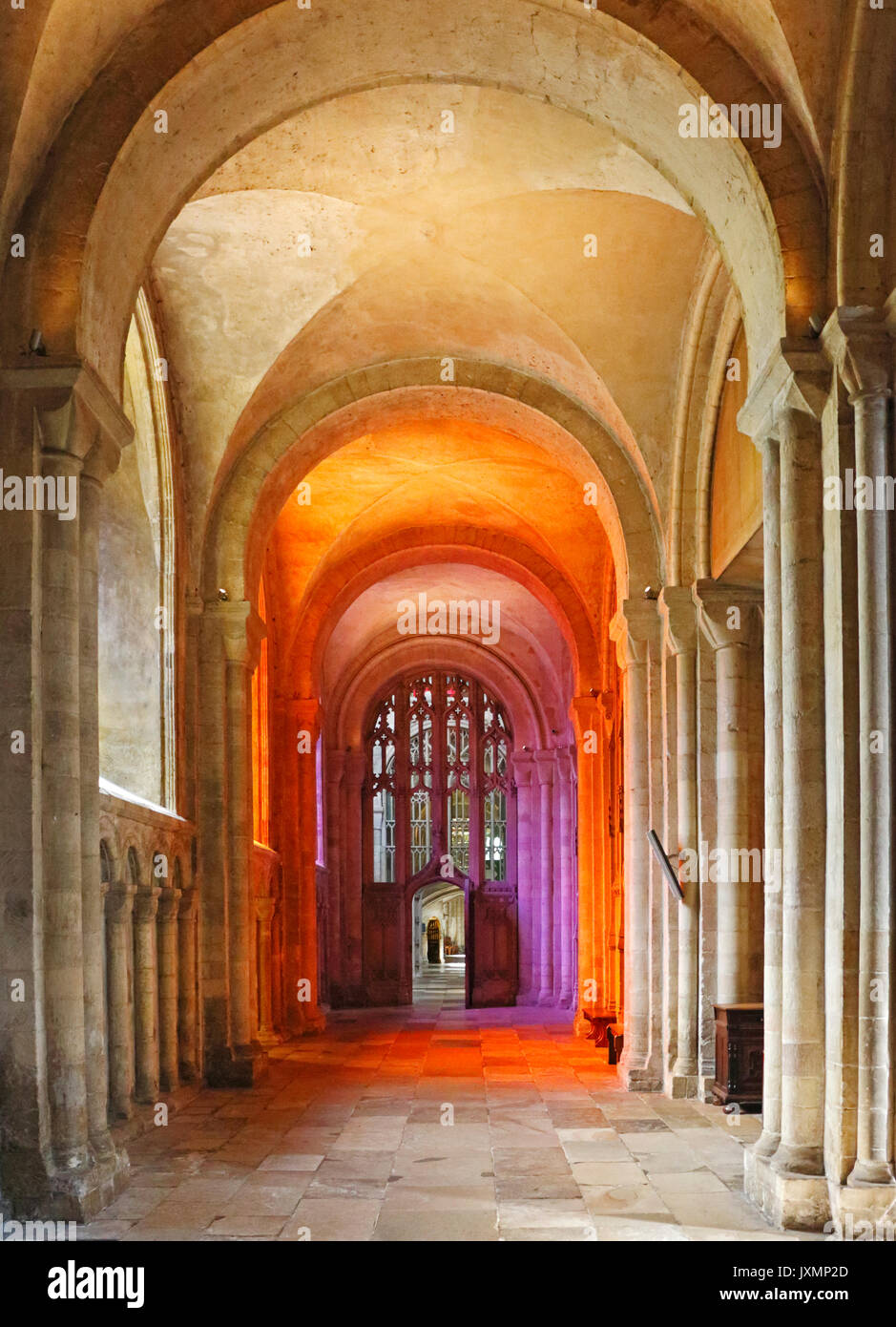 A view of coloured light flooding through the triptych of three modern stained glass windows in the North Aisle of Norwich Cathedral, Norfolk, UK. Stock Photo