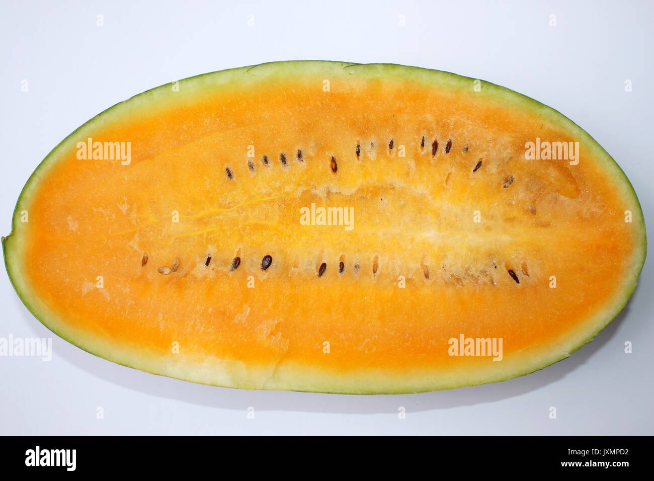 Half of watermelon with orange flesh isolated on white background Stock Photo