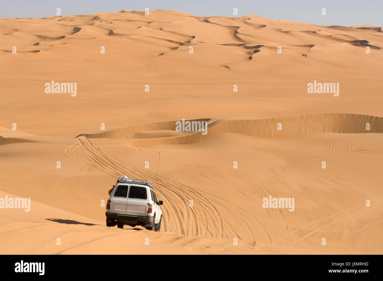 SUV on sand dunes, Erg Awbari, Sahara desert, Fezzan, Libya Stock Photo