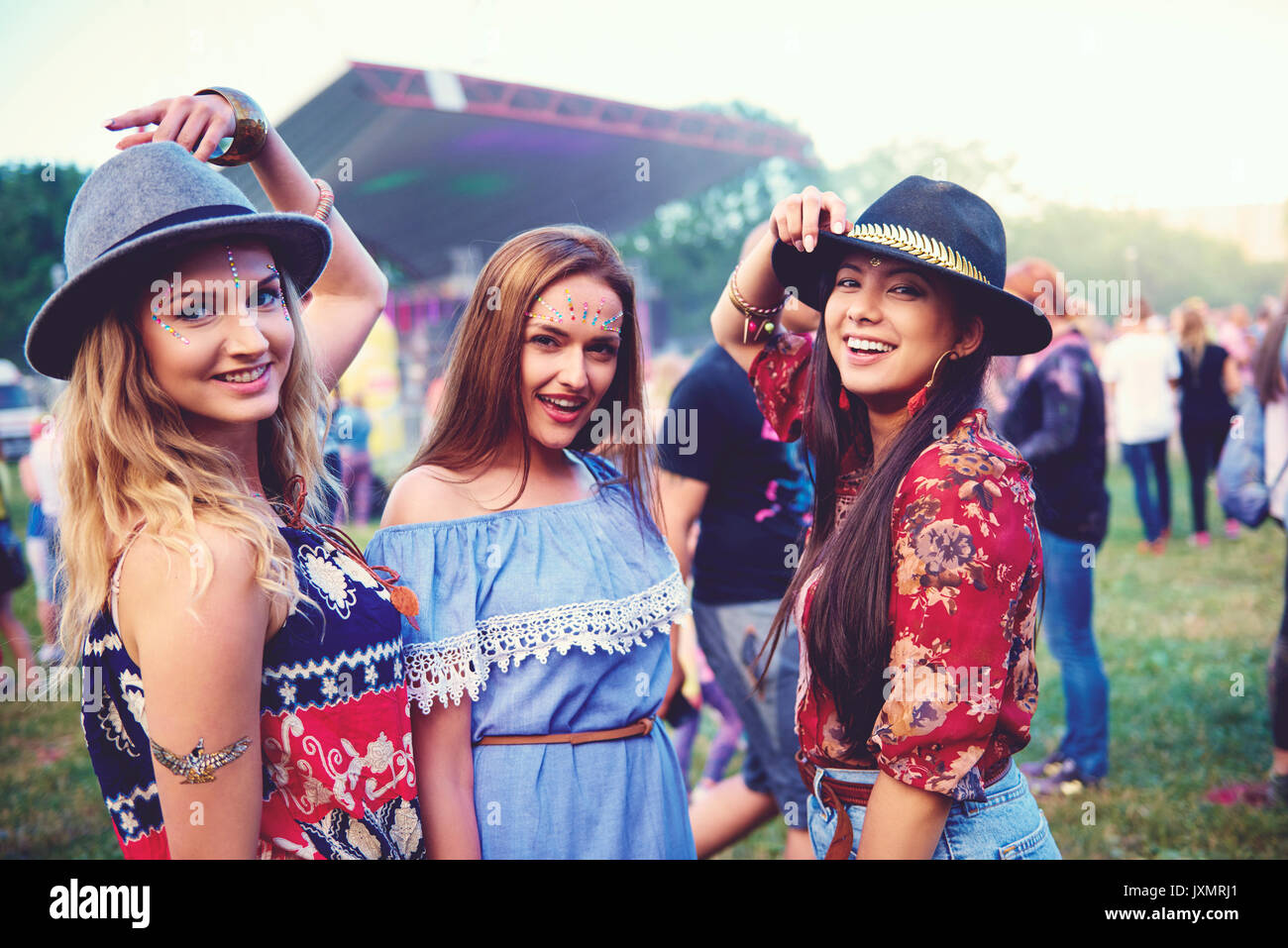 Portrait of three young female friends in trilbies at festival Stock Photo