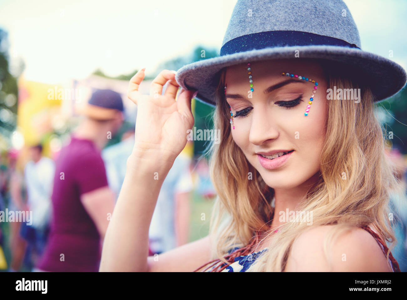 Young woman in trilby at festival Stock Photo