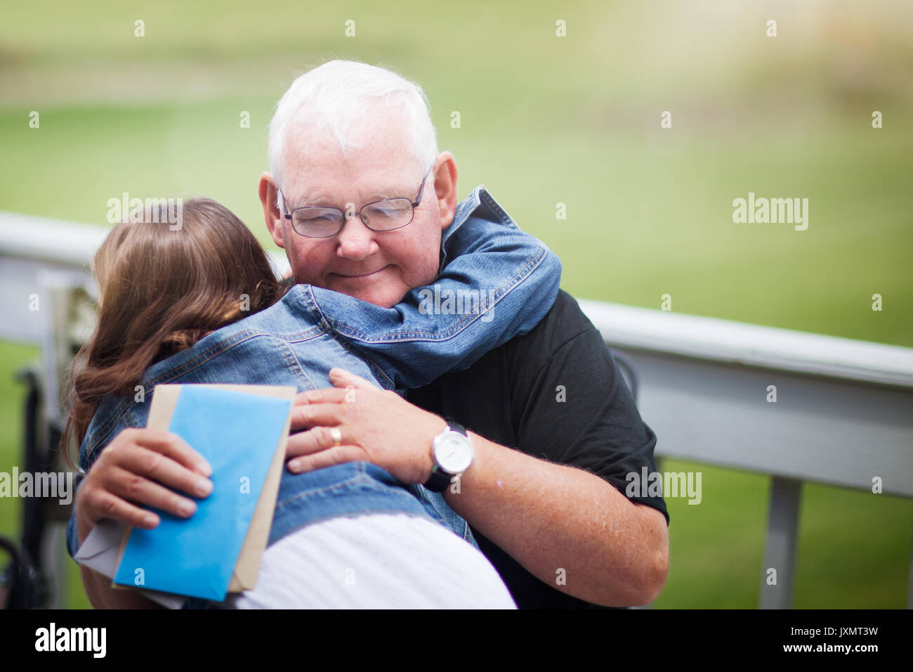Grandfather and grandchild hugging Stock Photo