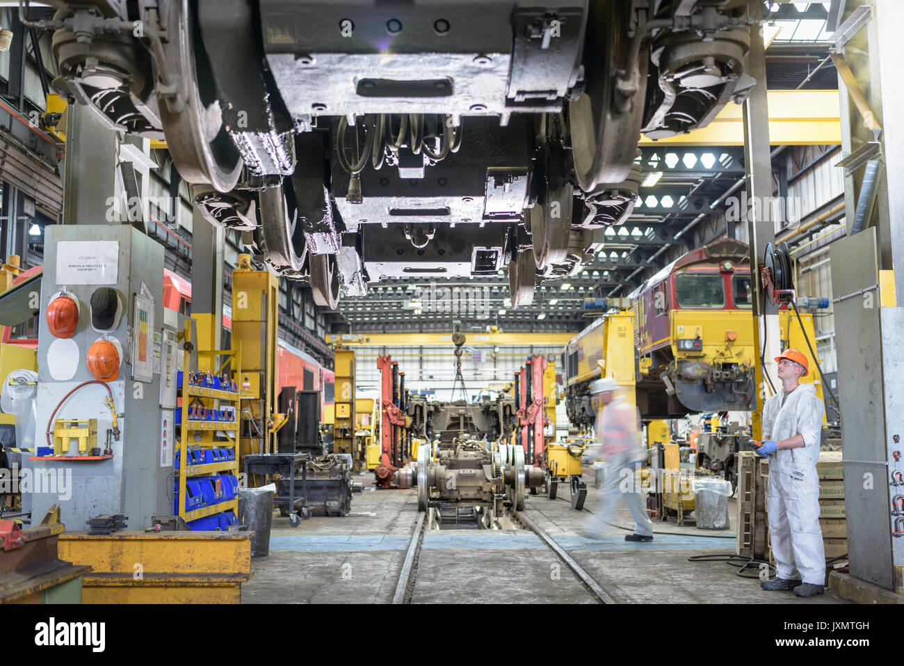 Locomotive engineers working on locomotive in train works Stock Photo