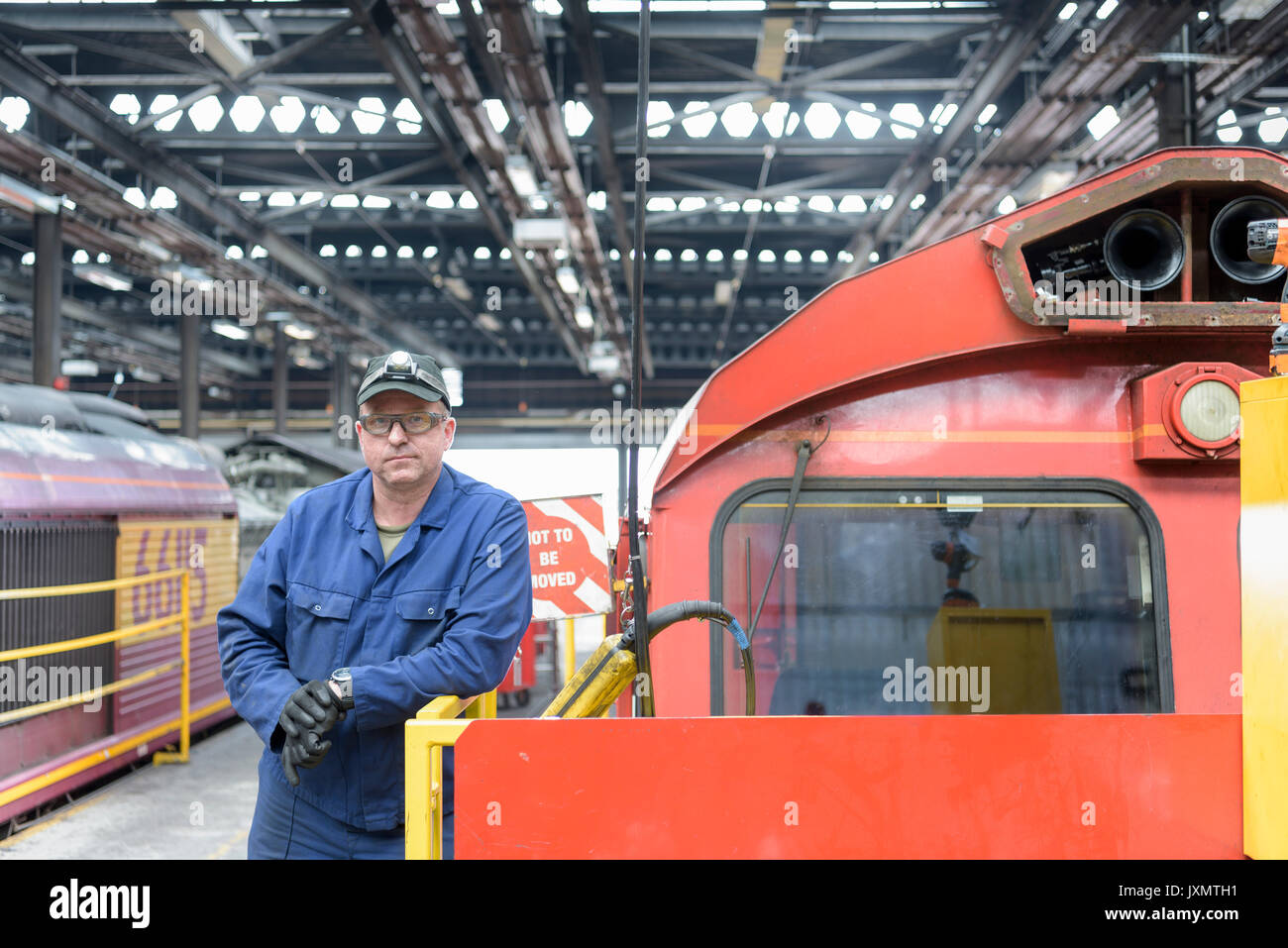 Portrait of locomotive engineer working in train works Stock Photo