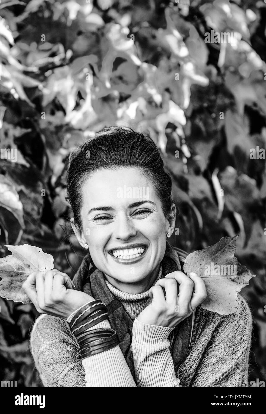 smiling young woman in front of autumn foliage Stock Photo - Alamy