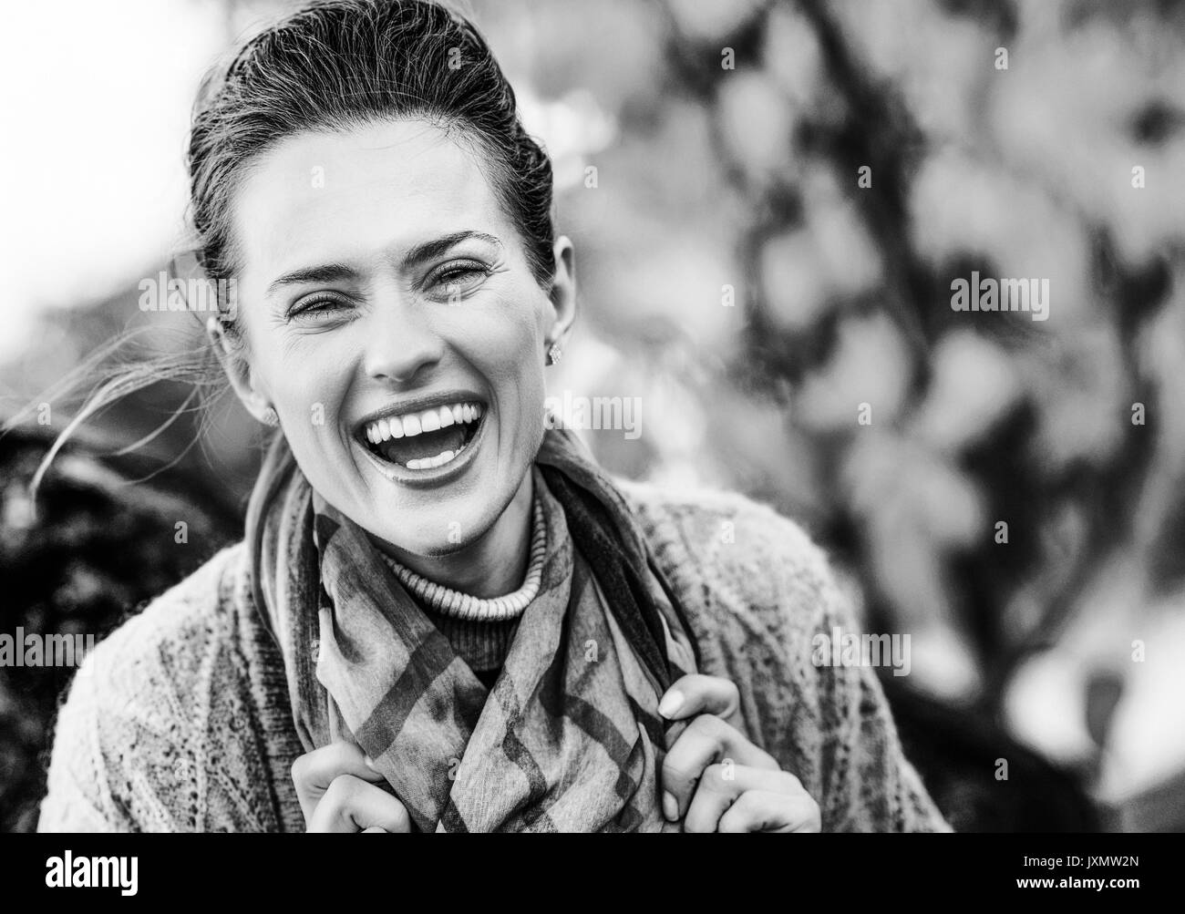 young laughing brunette woman relaxing in beautiful evening in autumn park Stock Photo