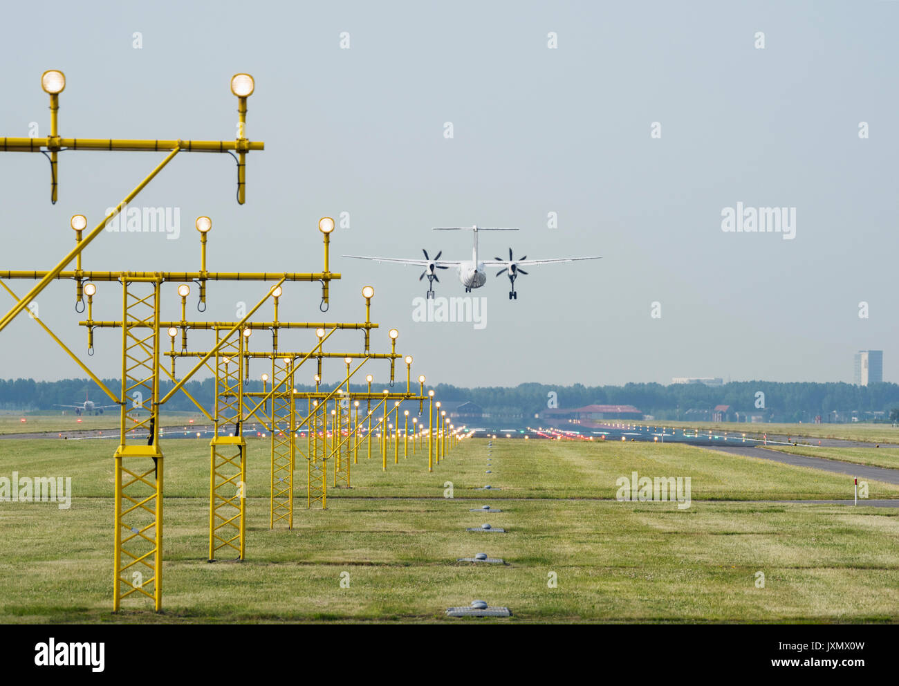 Airplane landing by runway landing lights, Schiphol, North Holland, Netherlands, Europe Stock Photo