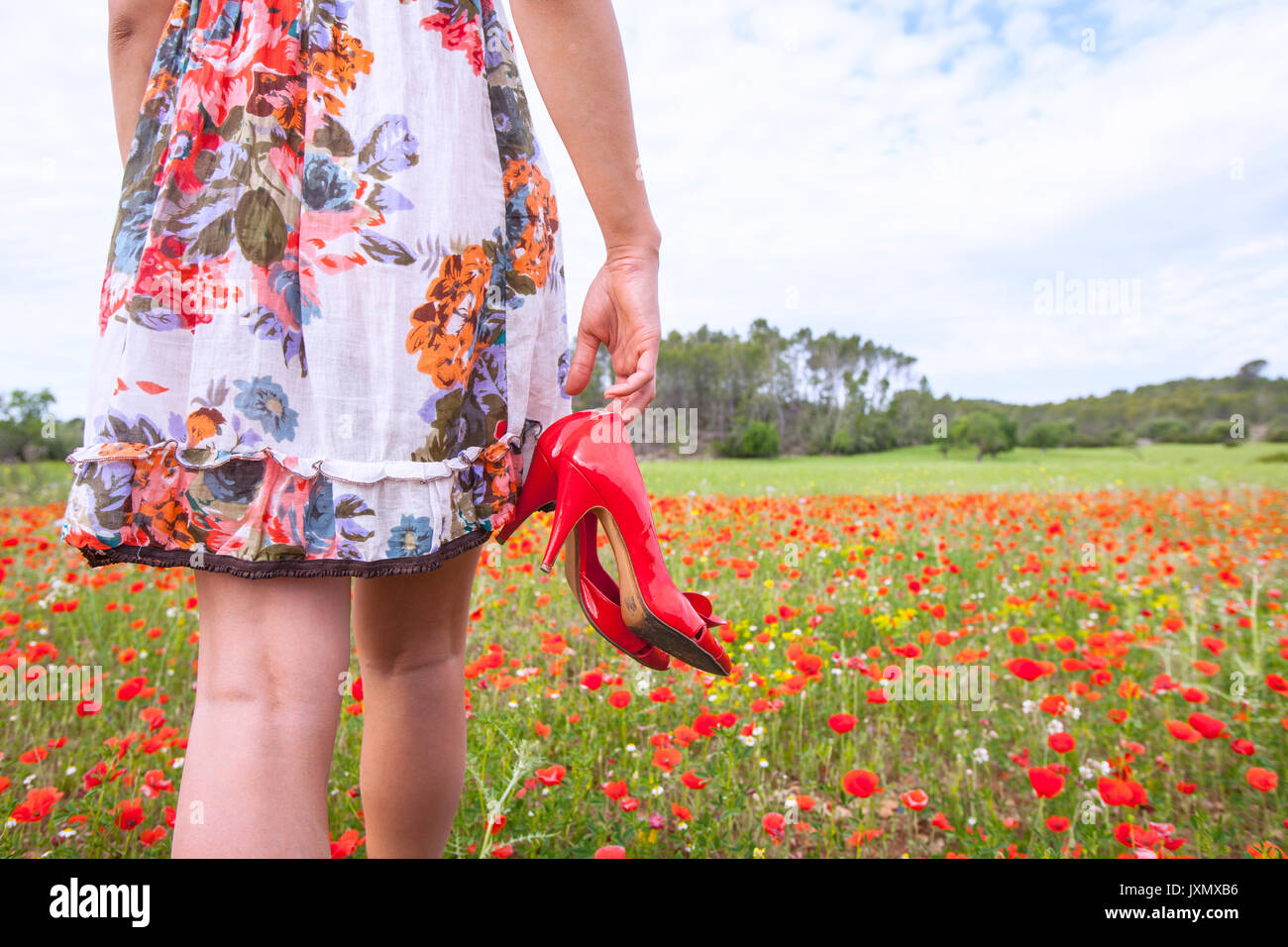 Woman walking in poppy field carrying high heel shoes, Palma de Mallorca,  Islas Baleares, Spain, Europe Stock Photo - Alamy