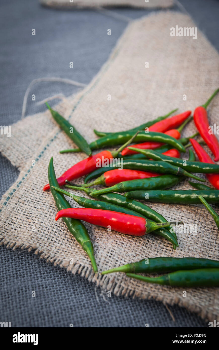 Still life of red and green chilli peppers on fabric Stock Photo