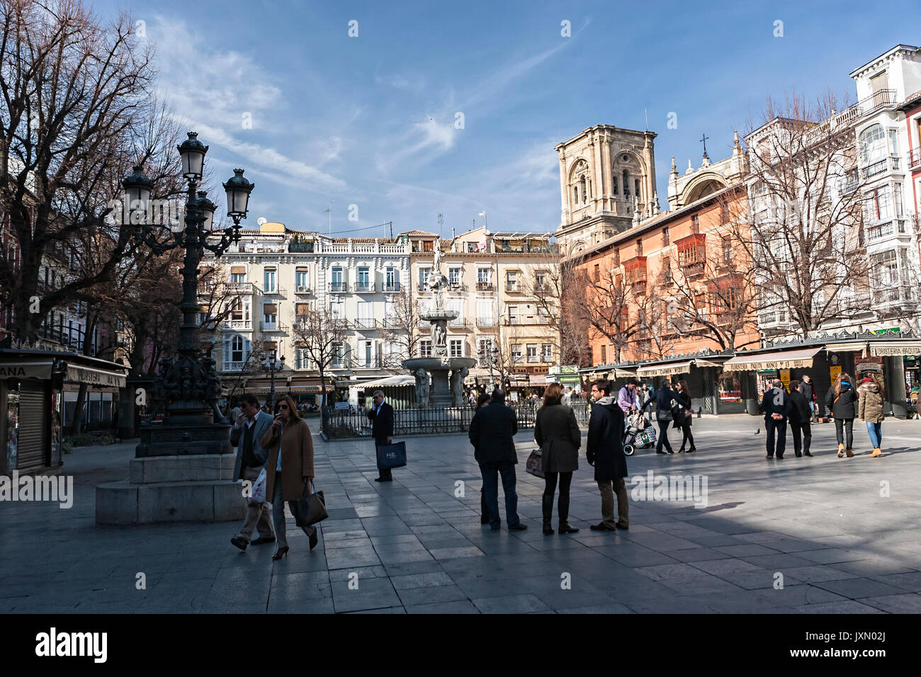 Tourists and locals strolling through the Bibarrambla square mid-afternoon, In moorish times, fair and festivals were celebrated here, Granada. Spain Stock Photo