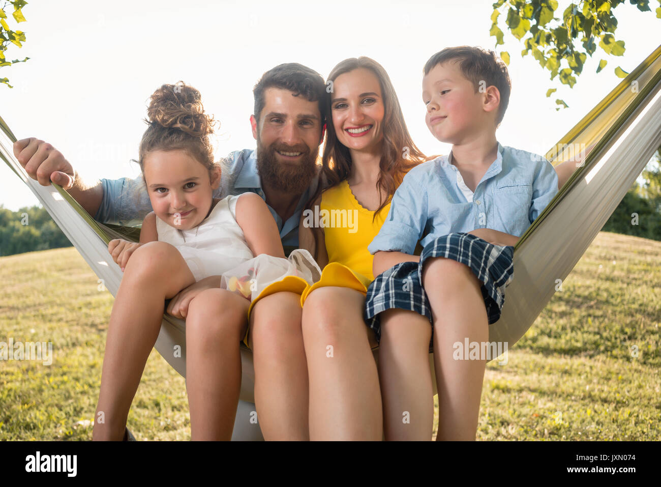 Family portrait with beautiful mother of two children next to he Stock Photo