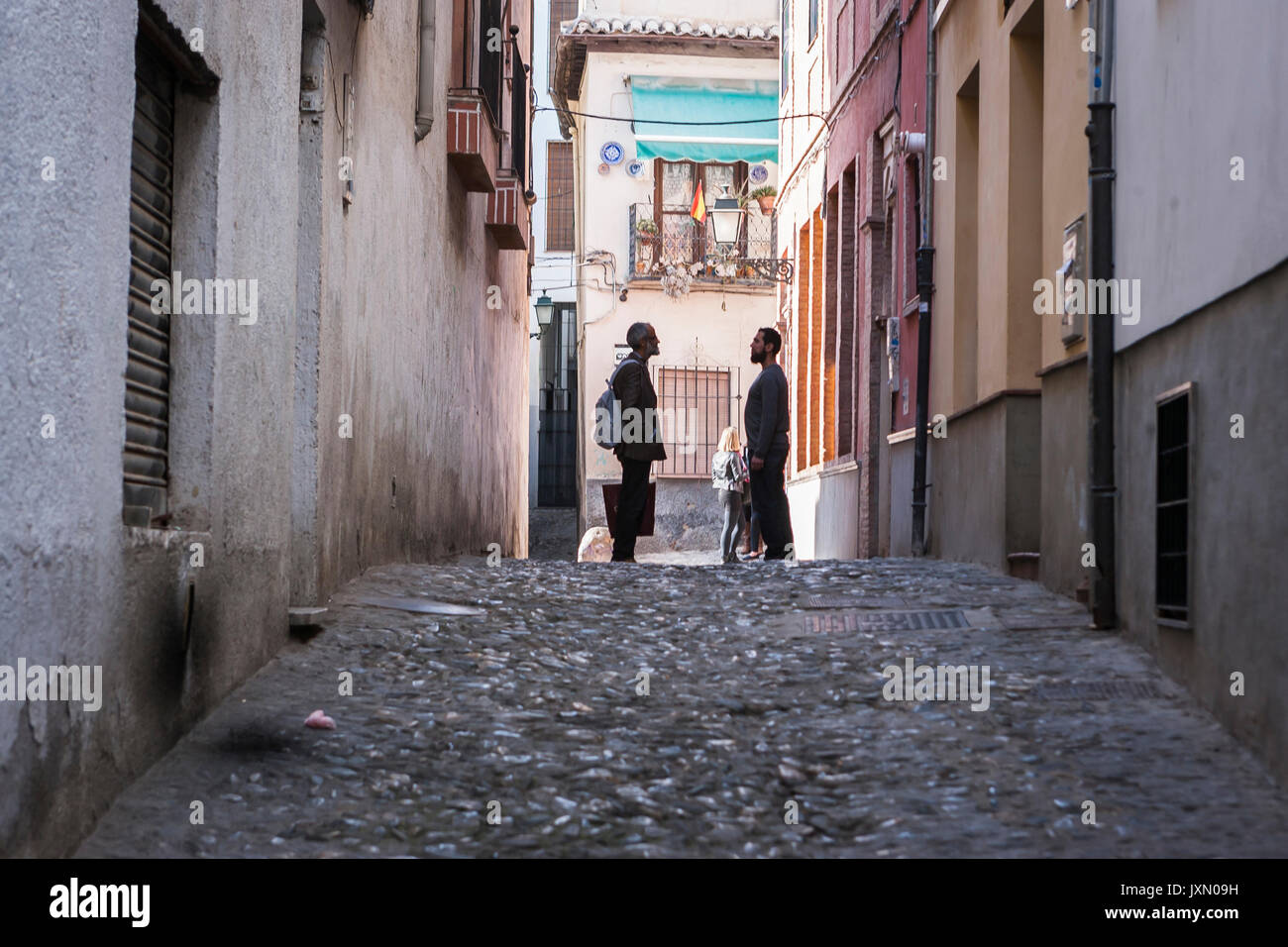 Two Moroccans speaking at the end of street in the Albaicín, Granada, Andalusia, Spain Stock Photo