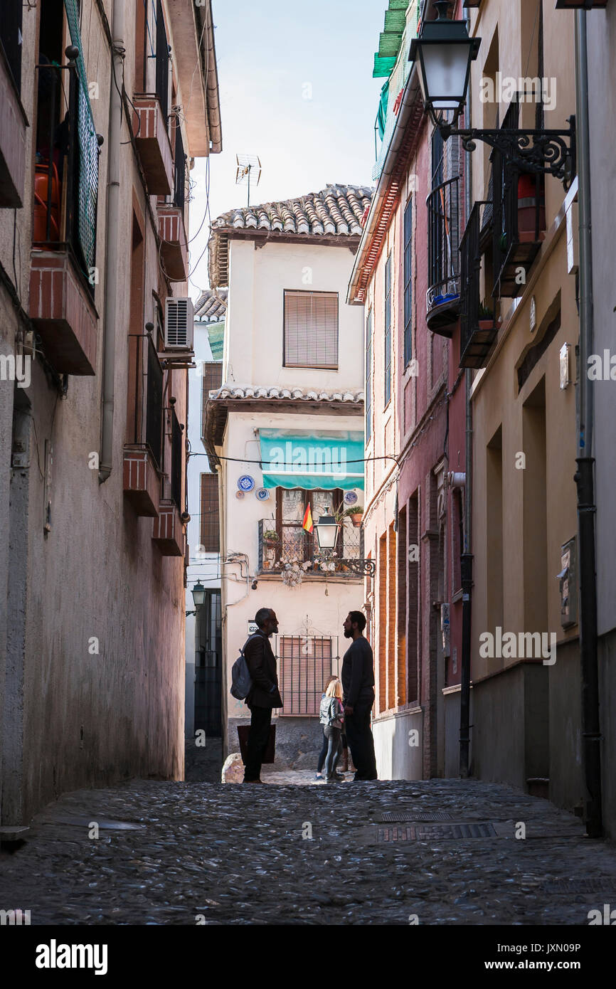 Two Moroccans speaking at the end of street in the Albaicín, Granada, Andalusia, Spain Stock Photo