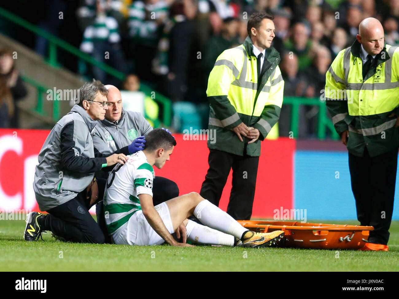 Celtic's Tom Rogic receives treatment for a head injury before being ...