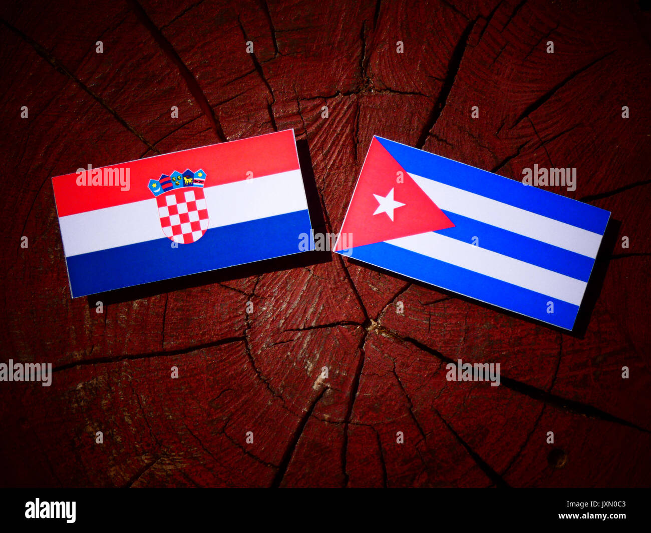 Croatian flag with Cuban flag on a tree stump isolated Stock Photo