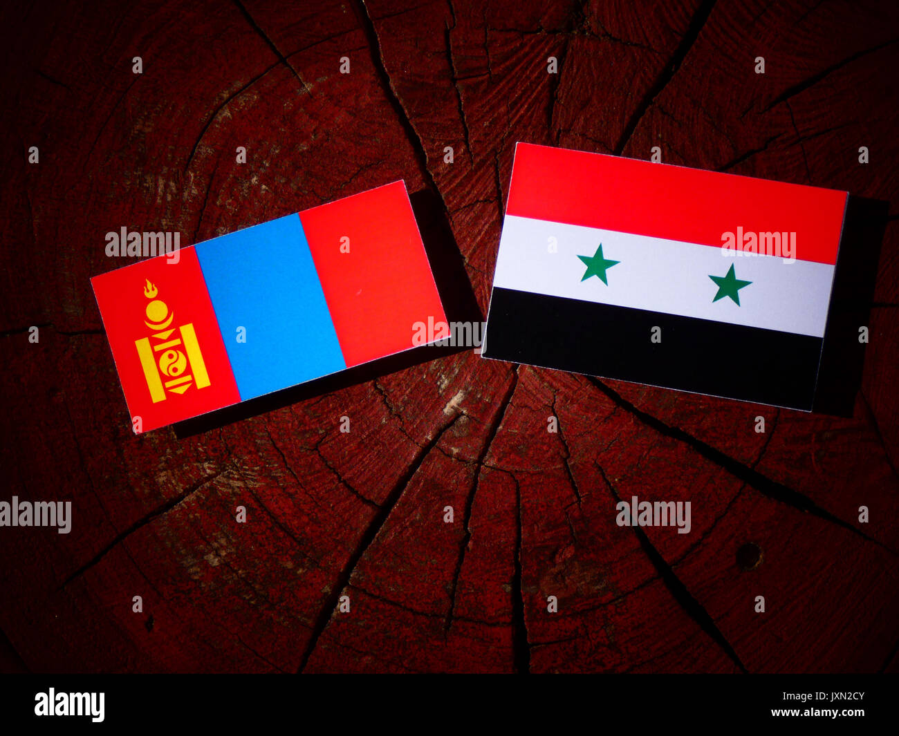 Mongolian flag with Syrian flag on a tree stump isolated Stock Photo