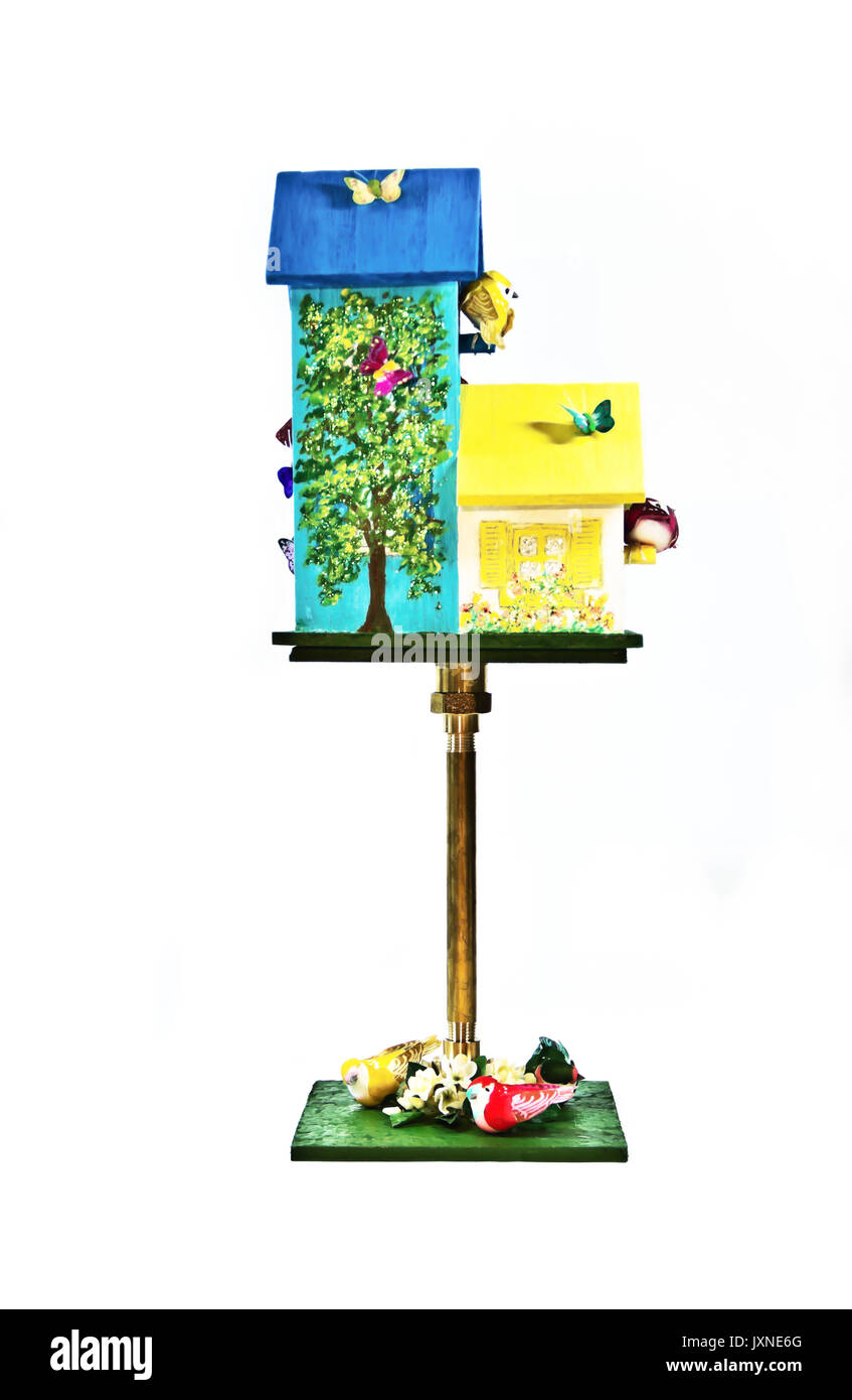 A double bird house of yellow and aqua hosts a flock of brightly