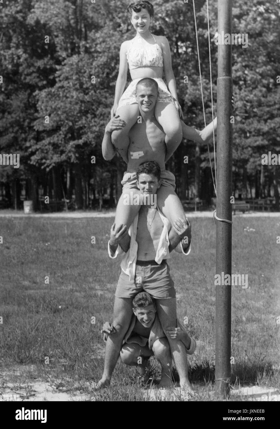 Student Life, Beach Party, Senior Week Candid shot of Hopkins students sitting on each others shoulders and forming a human totem pole at Triton beach, 1947. Stock Photo