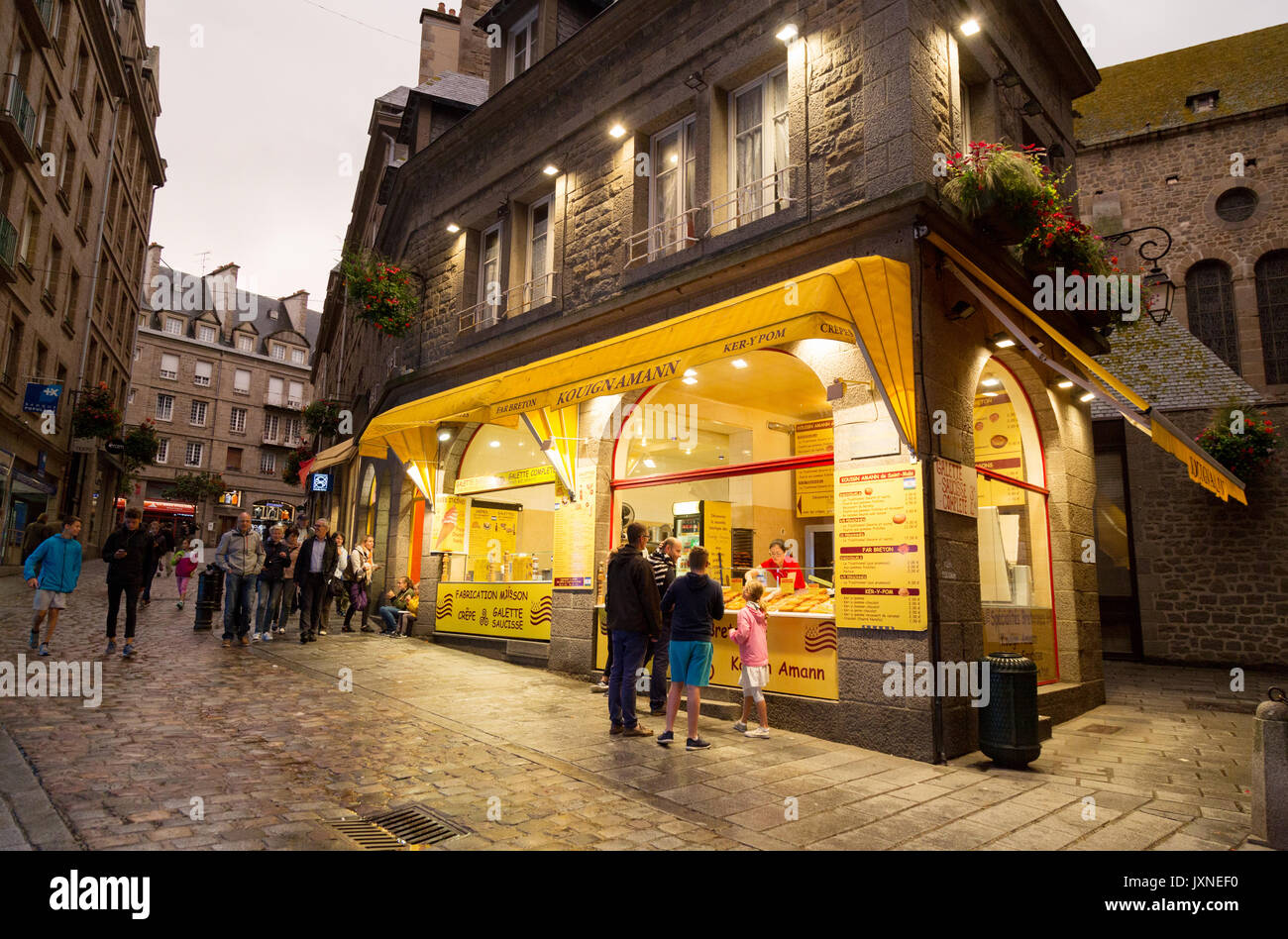 St Malo France - people at a french cafe in the  walled town at dusk, Saint Malo, old town, Brittany France Stock Photo