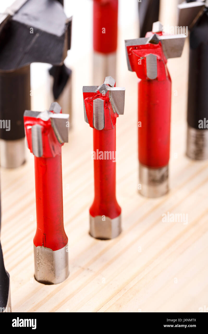 set of different drill bits for wood standing on wooden stand Stock Photo