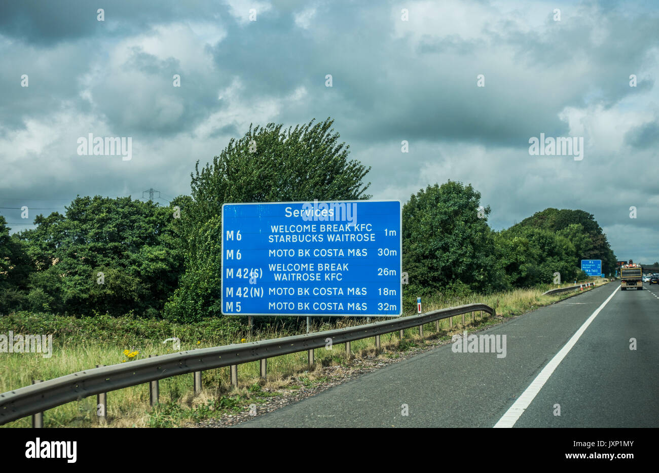 Signpost for services at various places, taken from the M6 motorway near Birmingham, heading west, England, UK. Stock Photo
