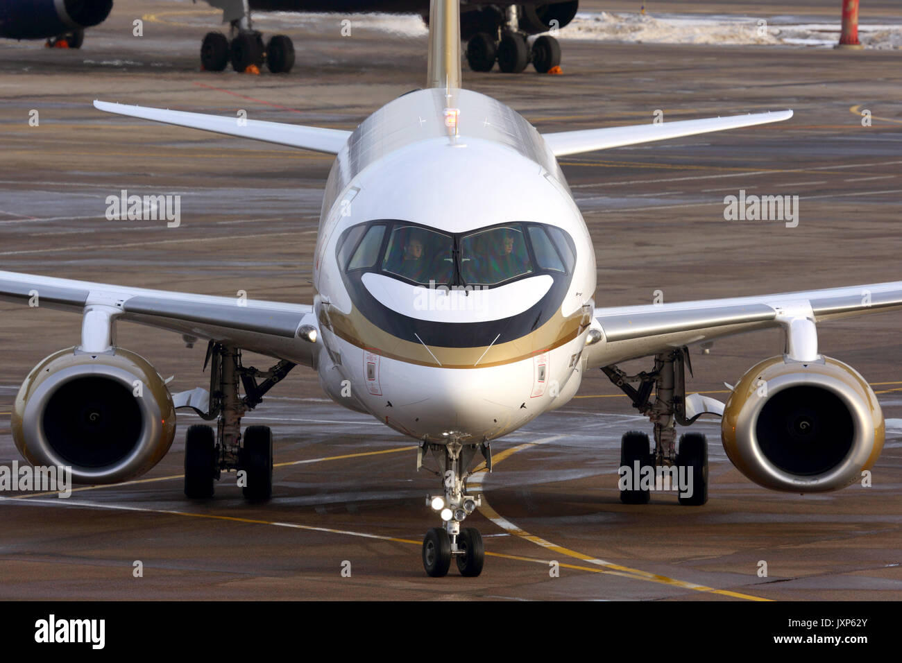 Sheremetyevo, Moscow Region, Russia - 23 March, 2014: Tsentr-Yug Sukhoi Superjet 100 RA-89004 in golden livery taxiing at Sheremetyevo international a Stock Photo