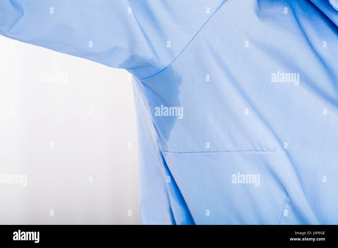 Close-up Of Young Woman Notices Her Sweat Under Armpit Stock Photo