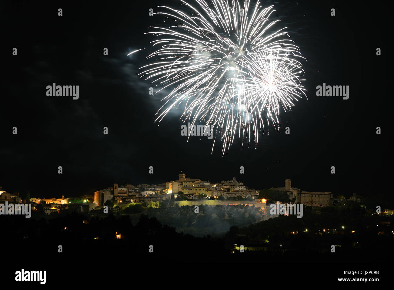 Night view of Montefalco (Italy) lighted by fireworks. Landscape format. Stock Photo