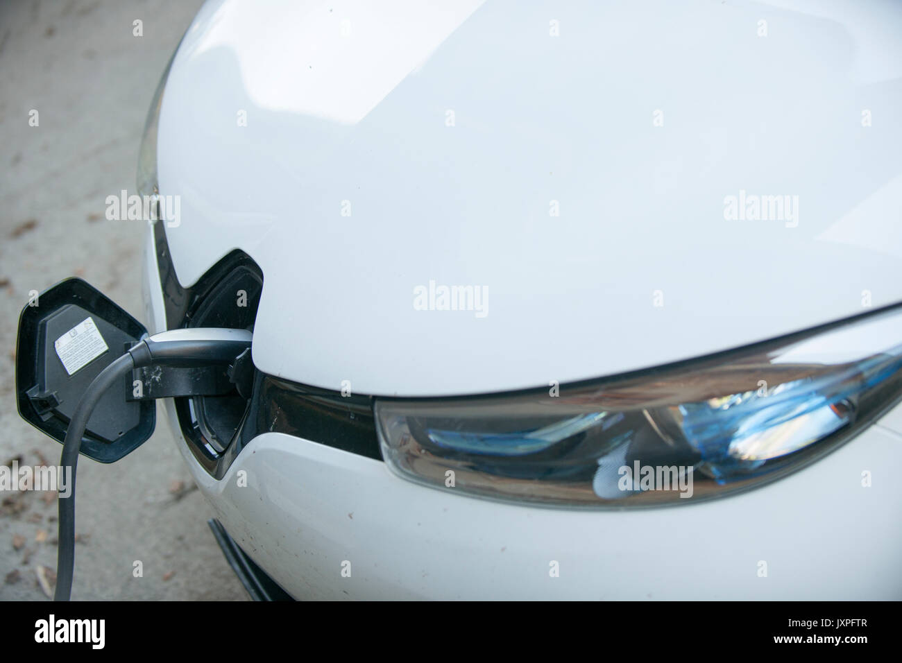 an electric car at a charging station Stock Photo
