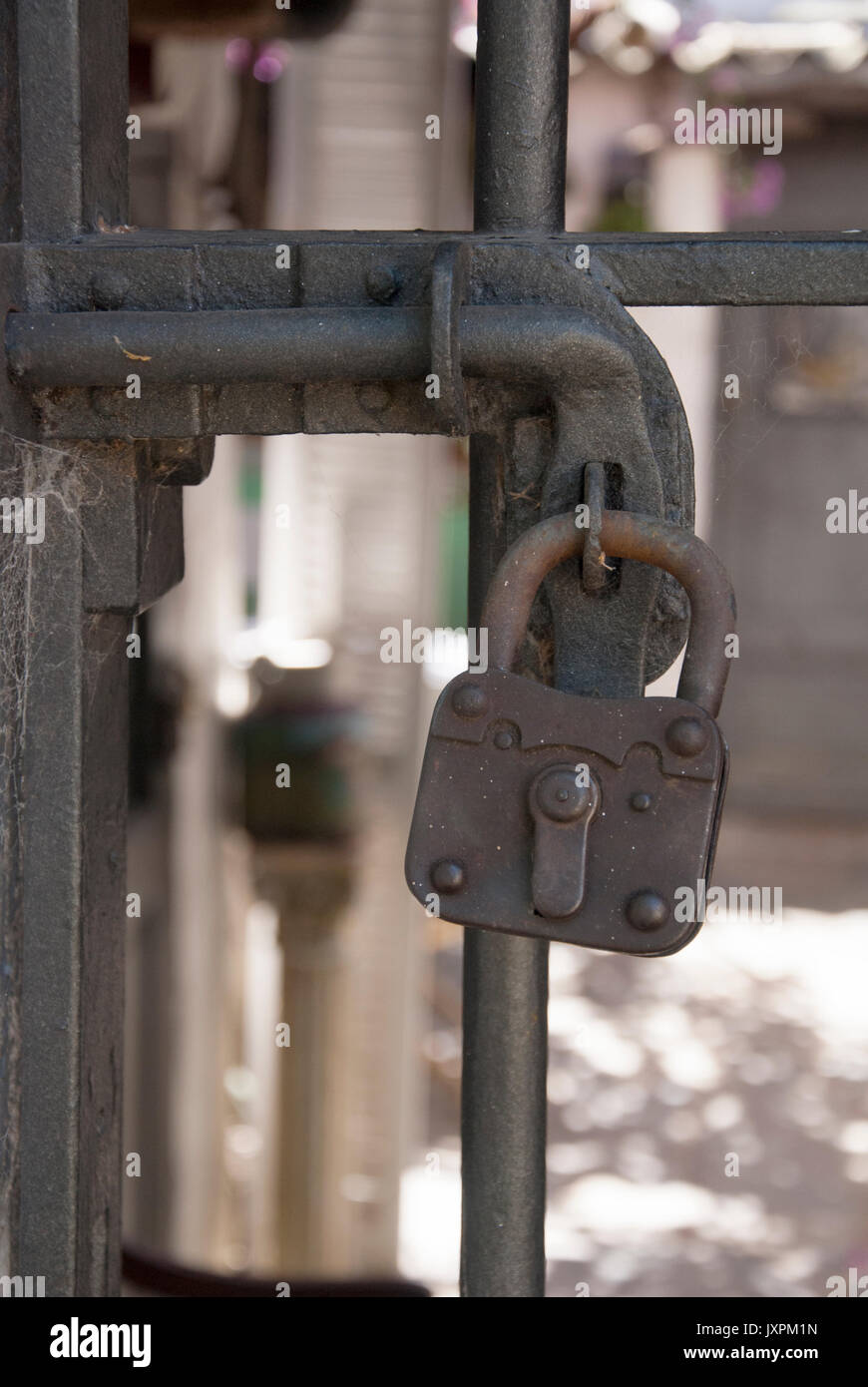 Security Device - Fence Secured With A Vintage Padlock Stock Photo