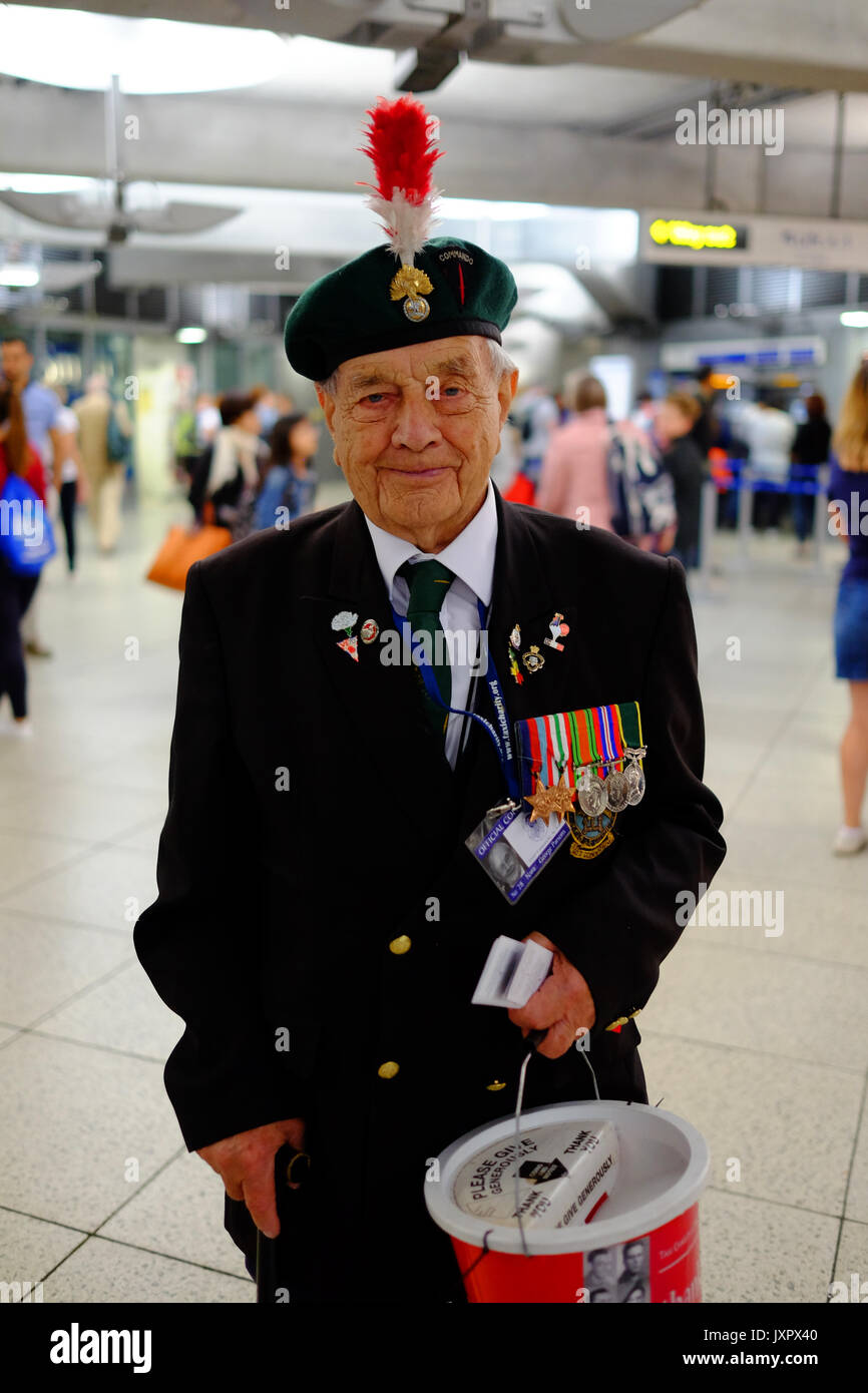 Military and Naval war veterans collecting at Westminster tube station for their taxi charity. Each had a bookmark with their service photo on it. Stock Photo